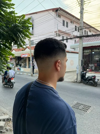 Skin fade haircut from the back outside the shop